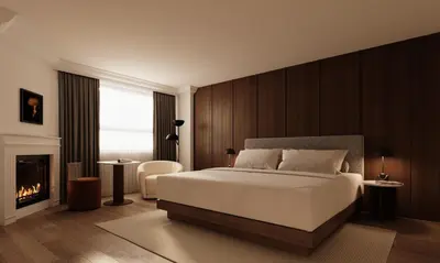 a bedroom with a large bed and a fireplace at Metcalfe Hotel Montréal by Gray Collection in Montréal