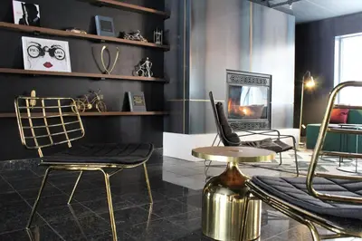 a room with two chairs and a table and a tv at LELUX Hotel in Montréal
