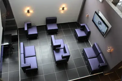 an overhead view of a waiting room with purple chairs at LELUX Hotel in Montréal