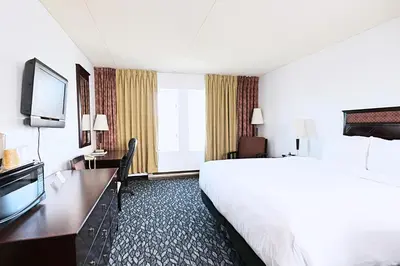 a hotel room with a large bed and a television at LELUX Hotel in Montréal