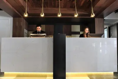 two people sitting at a desk in an office at LELUX Hotel in Montréal