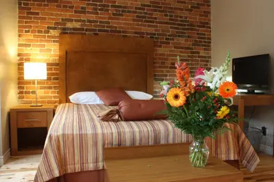 a bedroom with a bed with a vase of flowers at Hotel Quartier des Spectacles in Montréal