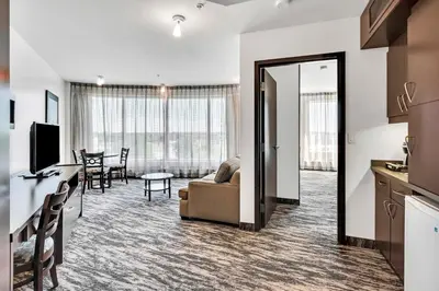 a living room with a couch and a table at Hotel Mortagne in Boucherville