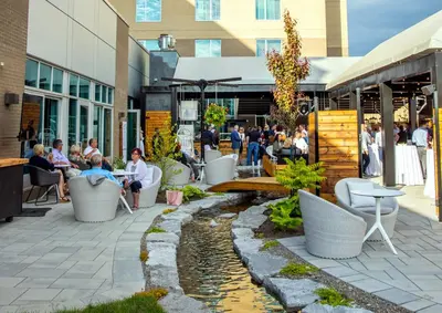 a group of people sitting outside of a building at Hotel Mortagne in Boucherville