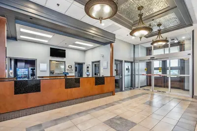 a lobby with a waiting area with a hair salon at Quality Suites in Drummondville