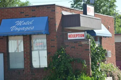a brick building with a sign for a motelemeteryemetery at Motel Chez Nous in Laval