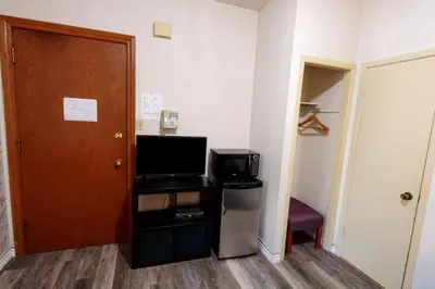 a room with a room with a door and a television at Hotel Casa Bella in Montréal