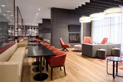 a restaurant with tables and chairs and a fireplace at Residence Inn by Marriott Montreal Airport in Dorval