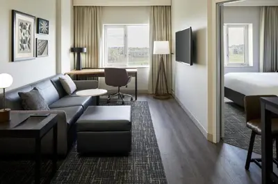 a hotel room with a couch and a bed at Residence Inn by Marriott Montreal Airport in Dorval