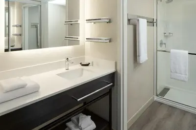 a bathroom with a sink and a mirror at Residence Inn by Marriott Montreal Airport in Dorval