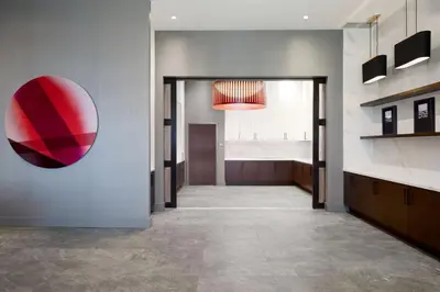 a hallway with a large red mirror on the wall at Residence Inn by Marriott Montreal Airport in Dorval