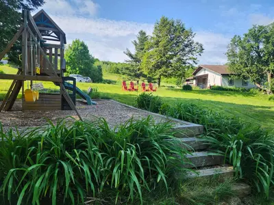 a playground with a slide and some plants at Auberge Schweizer in Sutton