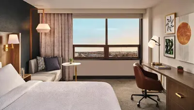a hotel room with a bed and a couch and a window at Holiday Inn St-Jean-sur-Richelieu Congrès by IHG in Saint-Jean-sur-Richelieu