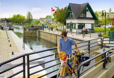 a man standing with a bike next to a railing at Holiday Inn St-Jean-sur-Richelieu Congrès by IHG in Saint-Jean-sur-Richelieu