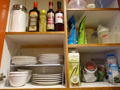 a kitchen pantry with dishes and wine bottles at Gite à Coté in Montréal