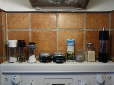 a counter top with spices and bottles on it at Gite à Coté in Montréal