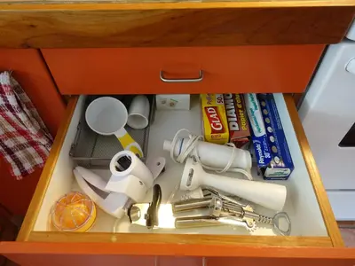 a drawer in a cabinet filled with a kitchen utensils at Gite à Coté in Montréal