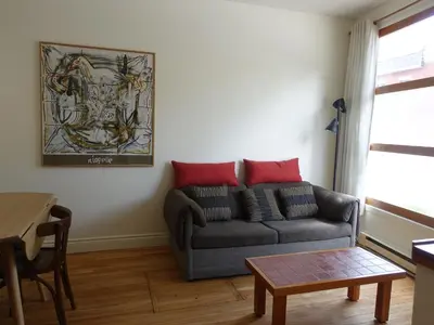 a living room with a couch and a table at Gite à Coté in Montréal