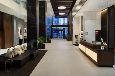 a lobby of a building with a long couch at Hôtel AC Montréal Centre-ville in Montréal