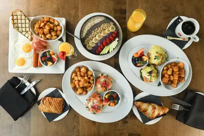 a table topped with plates of food and drinks at Hôtel AC Montréal Centre-ville in Montréal