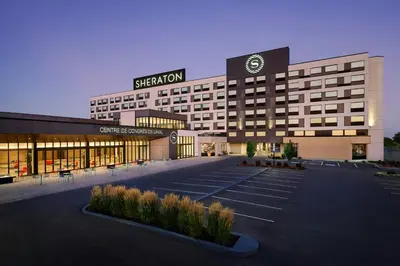 a large building with a sign on top of it at Sheraton Laval Hotel in Laval