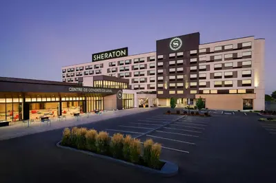a large building with a sign on top of it at Sheraton Laval Hotel in Laval