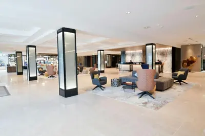 a lobby with couches and chairs in a building at Sheraton Laval Hotel in Laval