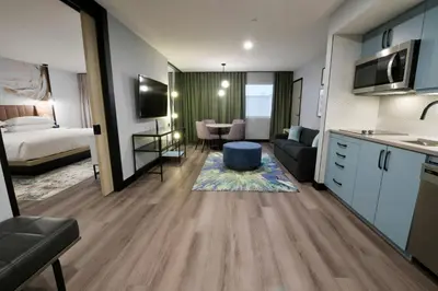 a hotel room with a kitchen and a living room at Sheraton Laval Hotel in Laval
