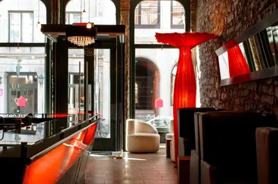 a room with a red dress on the wall at Le Petit Hôtel Vieux-Montréal - Saint-Paul by Gray Collection in Montréal