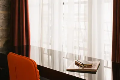 a table with two books on it next to a window at Le Petit Hôtel Vieux-Montréal - Saint-Paul by Gray Collection in Montréal