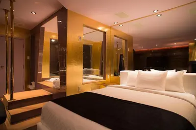 a bedroom with a large bed and a bathroom at Hôtel Le Rivage in Rosemère