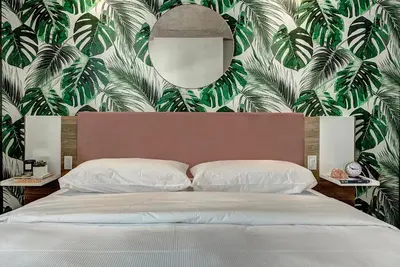 a bedroom with a large bed with a large mirror at Pierce Boutique Apartments by Simplissimmo in Montréal