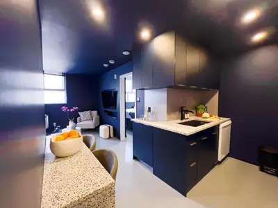 a kitchen with blue cabinets and a table with oranges on it at Pierce Boutique Apartments by Simplissimmo in Montréal