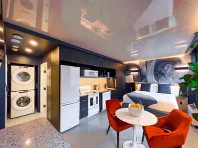 a bedroom with a bed and a table and a kitchen at Pierce Boutique Apartments by Simplissimmo in Montréal
