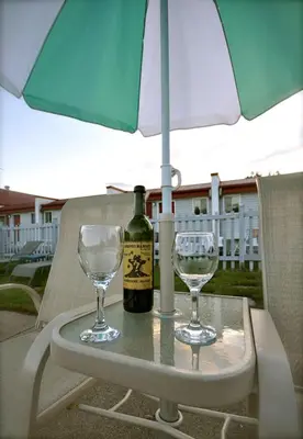 a table with a bottle of wine and two glasses at Motel de la Pente Douce in Magog-Orford