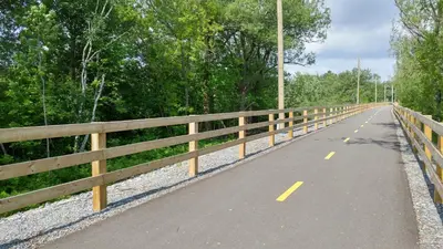 an empty road with a fence on the side at Motel de l'Outlet in Magog-Orford