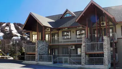 a large house with a gambrel roof at Au pied des pentes in Bromont