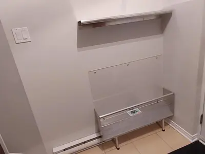a walk in closet with a metal shelf in a room at Au pied des pentes in Bromont
