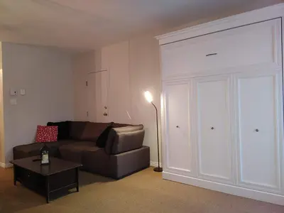 a living room with a couch and a sliding door at Au pied des pentes in Bromont