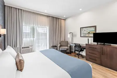 a hotel room with a bed and a desk at Best Western Plus Montreal East in Montréal