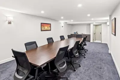 a conference room with a wooden table and chairs at Best Western Plus Montreal East in Montréal