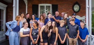 a group of people standing in front of a house at Manoir Becancourt Hotel in Bécancour