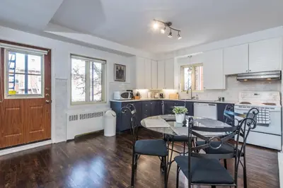a kitchen with a table and chairs in a room at Gite du Survenant Montreal in Montréal