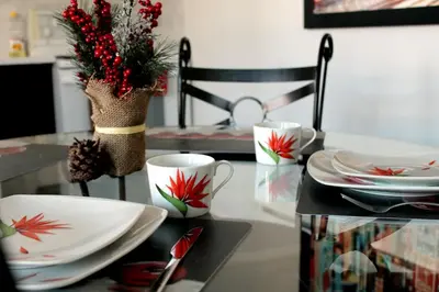 a dining room table with plates and cups on it at Gite du Survenant Montreal in Montréal