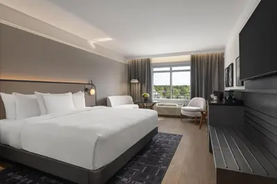 a hotel room with a large bed and a window at Hotel Vallea Bromont, Tapestry Collection by Hilton in Bromont