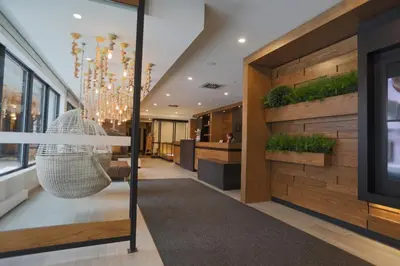 a lobby with a wicker swing in a building at Espace 4 Saisons in Magog-Orford