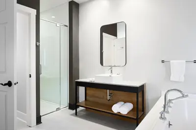 a bathroom with a sink and a mirror and a shower at Espace 4 Saisons in Magog-Orford