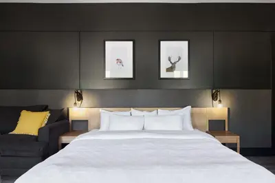 a bedroom with a large white bed and a couch at Espace 4 Saisons in Magog-Orford