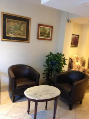 a living room with two chairs and a table at Hotel Bon Accueil in Montréal
