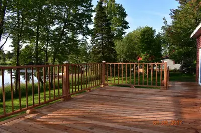 a wooden ramp leading to a house with a fence at Domaine Henri-Daze in Saint-Pierre-Baptiste
